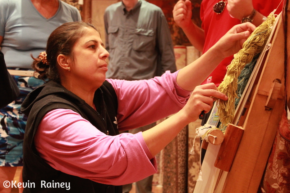 A Turkish woman weaving carpets